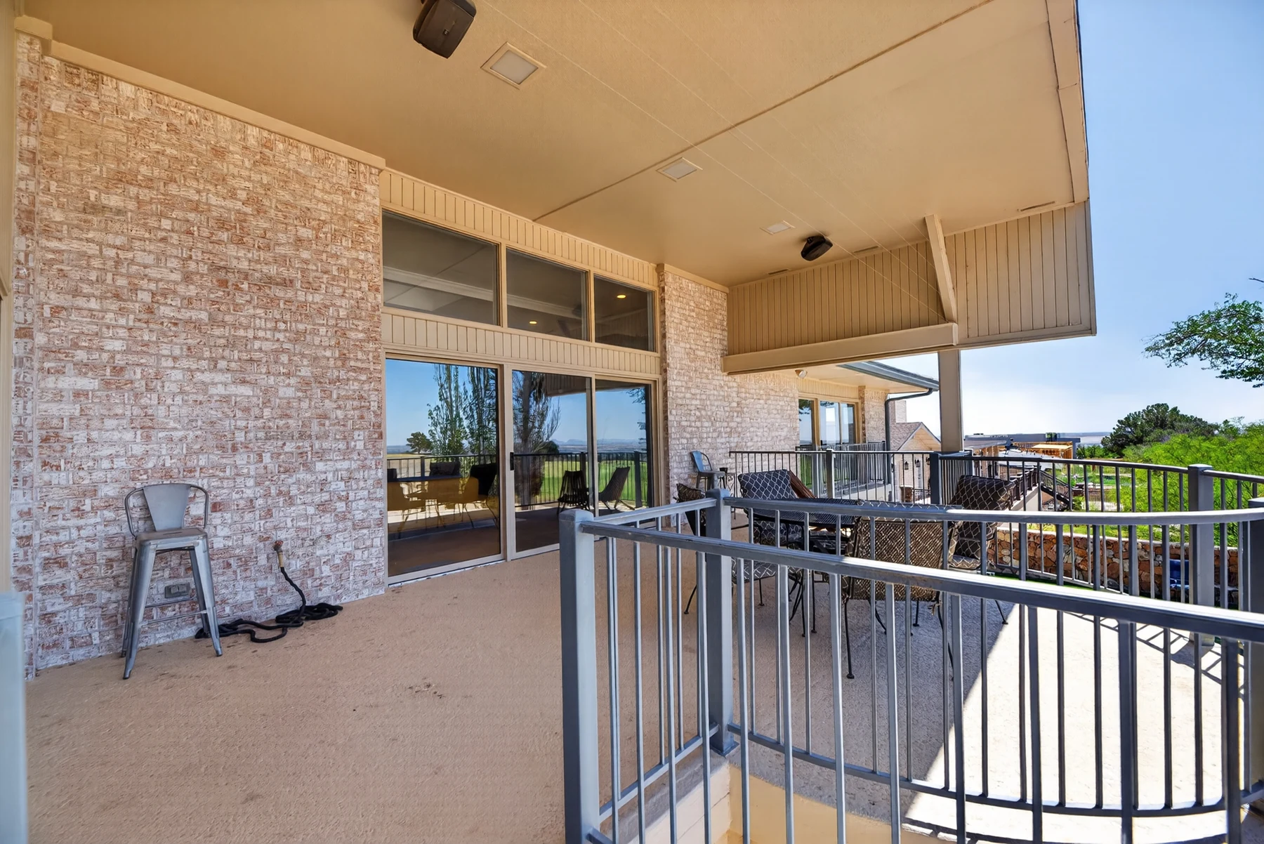 Covered balcony overlooking outdoor spaces and golf course