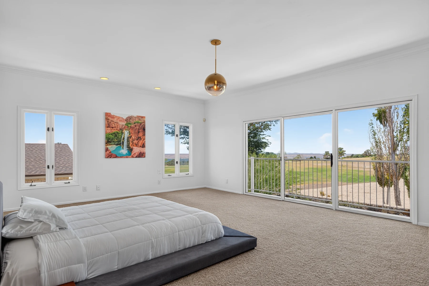 Bedroom with broad windows and golf-course outlook