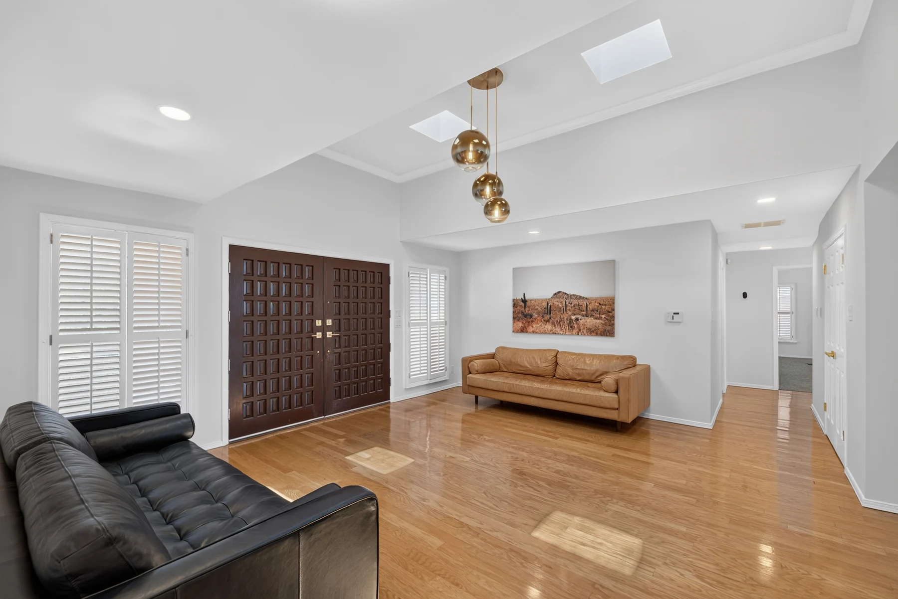 Main living and entry area with wood floors and detailed ceiling work
