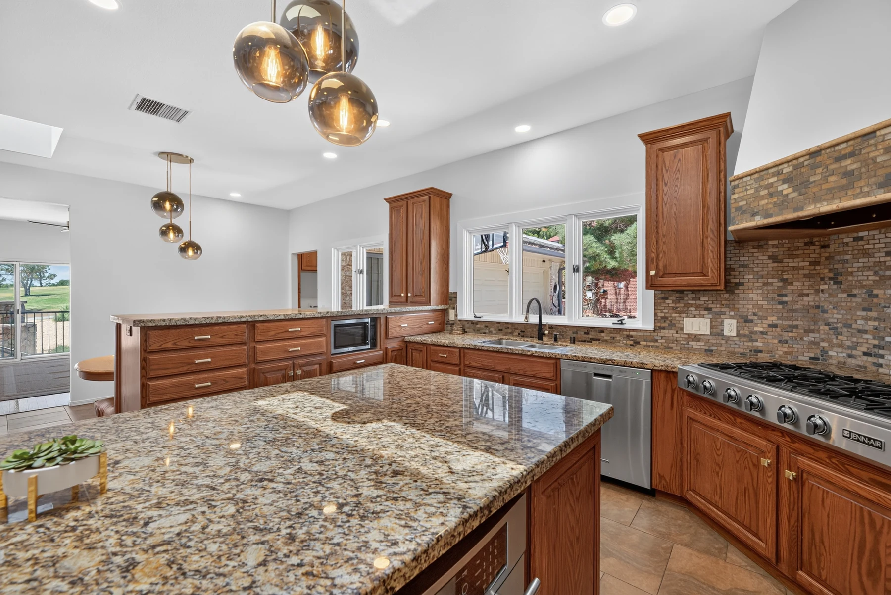 Kitchen detail with stone counters and wood cabinetry