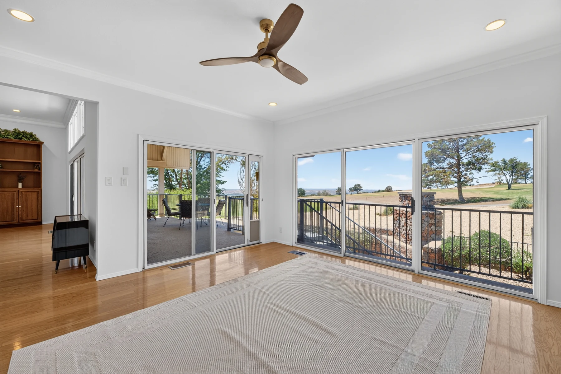Living area opening to a balcony and outdoor views