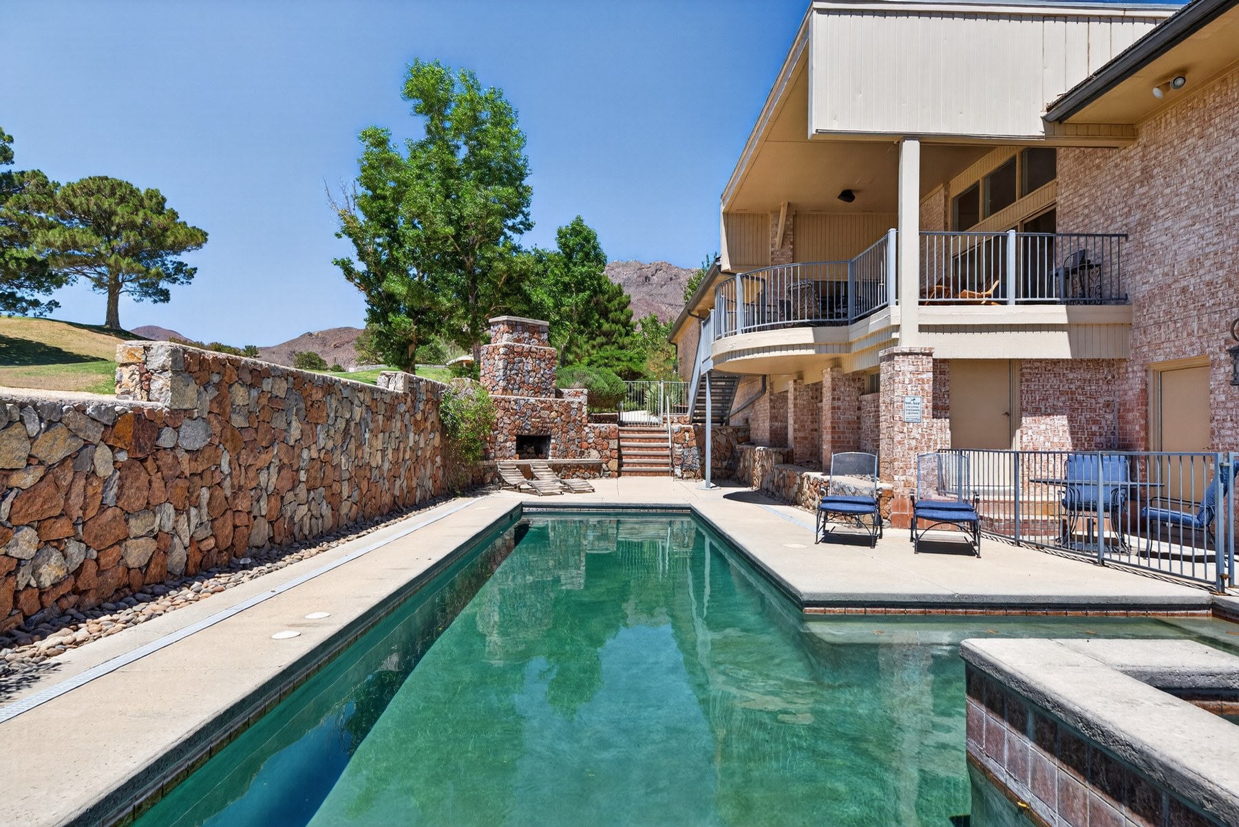 Heated saltwater pool and multi-level outdoor living areas at 1013 Singing Hills